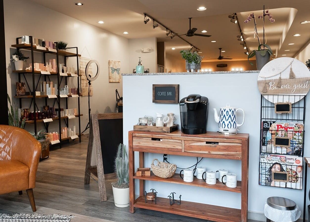 Welcoming seating area at Expressions Hair Studio in Reading, Massachusetts, US with coffee bar and products.