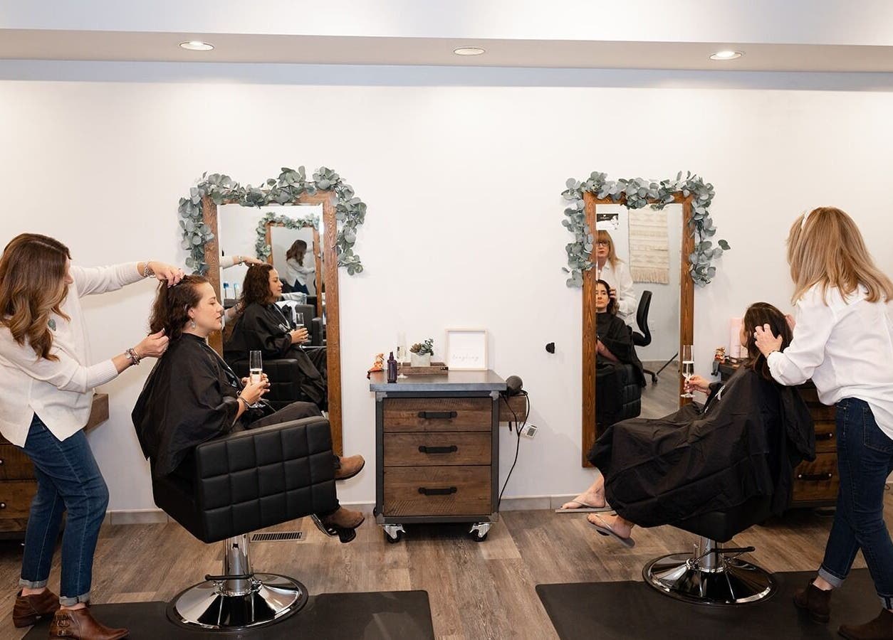 Stylists in action at Expressions Hair Studio, Reading, Massachusetts, US, showcasing modern salon experience.
