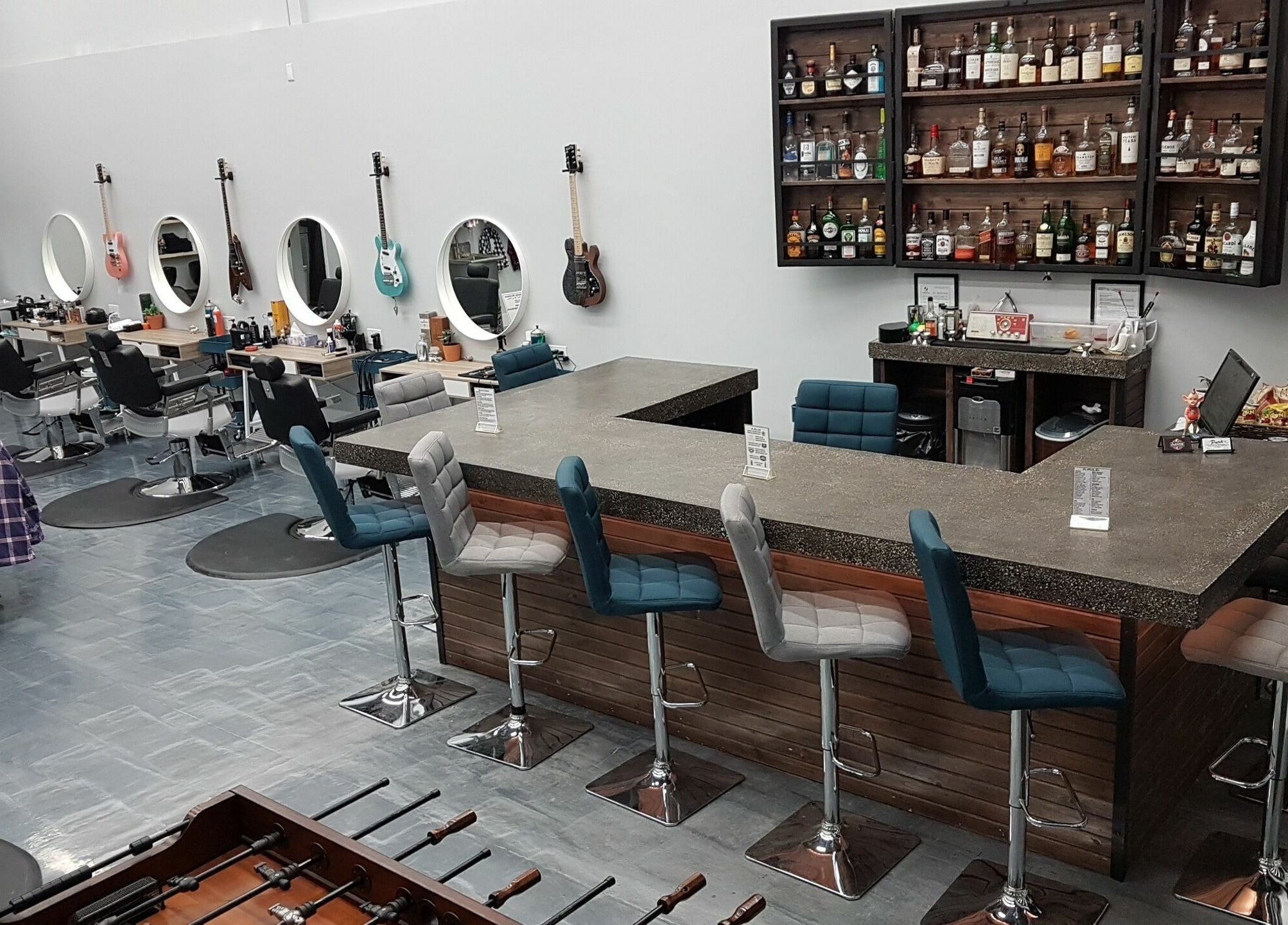 Stylish interior of Blackstone Barbers and Beardsmiths in Saskatoon, Saskatchewan, CA with bar seating and guitars.