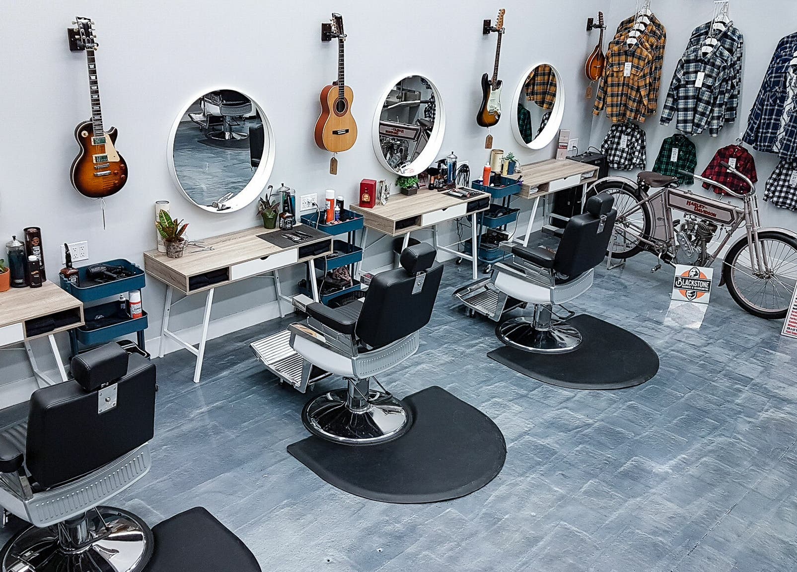 Modern interior of Blackstone Barbers and Beardsmiths in Saskatoon, Saskatchewan, CA with guitar decor.