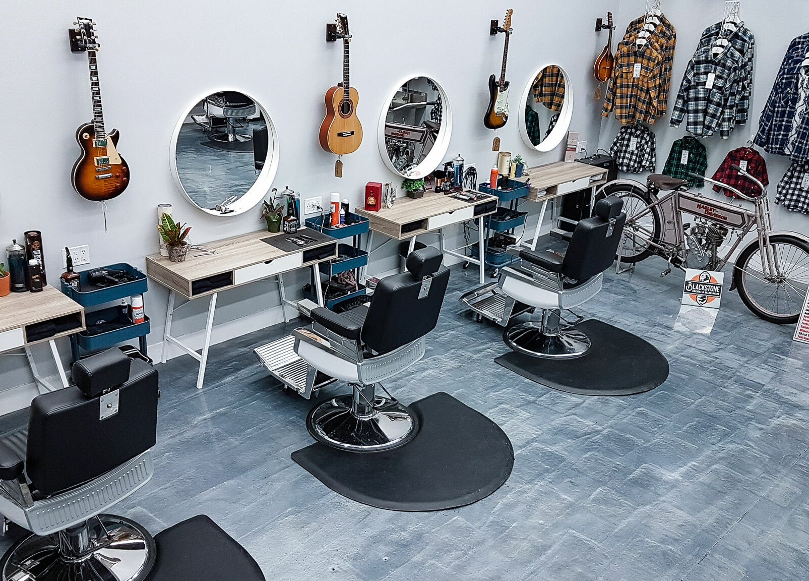 Modern interior of Blackstone Barbers and Beardsmiths in Saskatoon, Saskatchewan, CA with guitar decor.