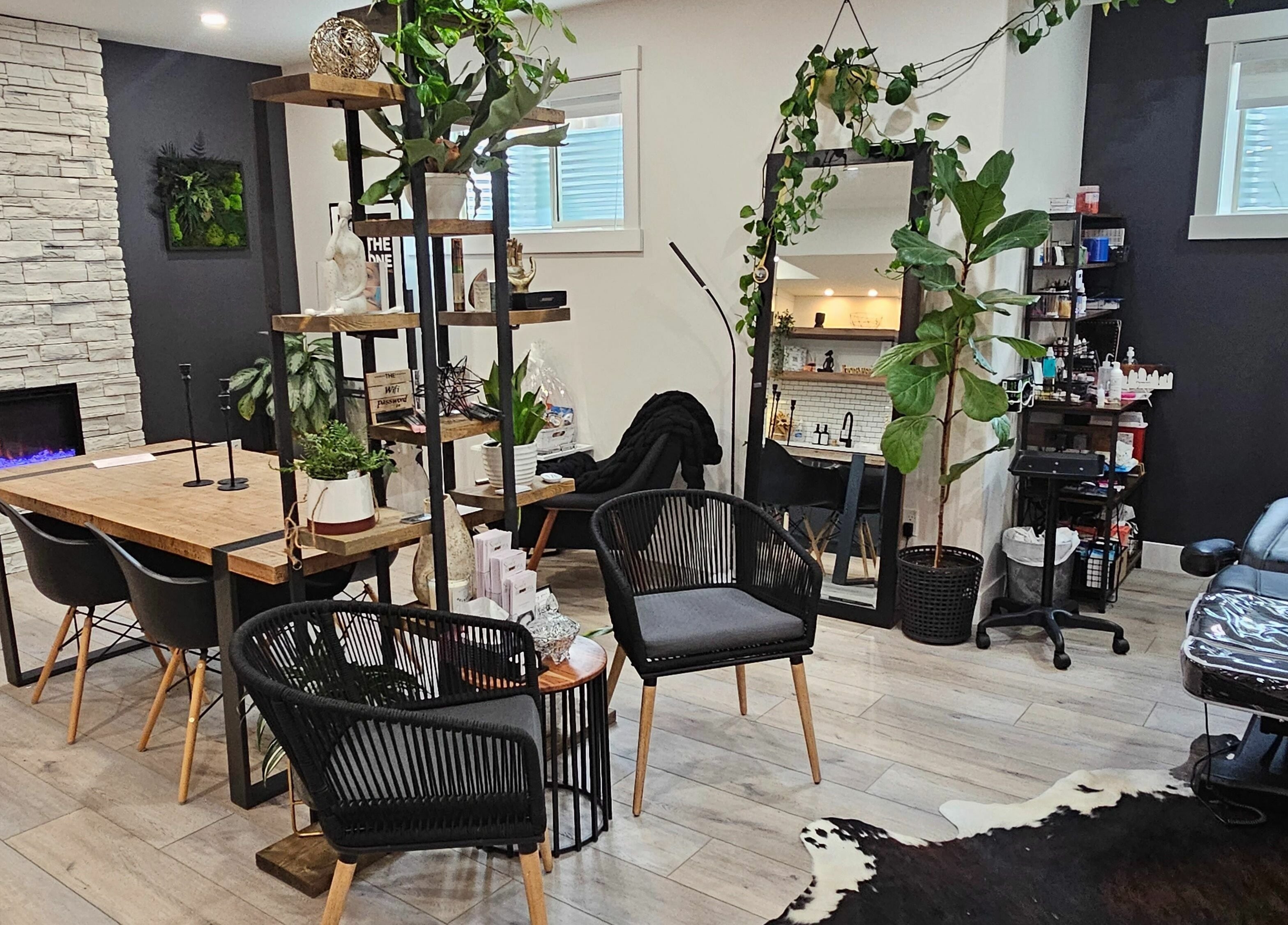 Chic interior of Simply BeYoutiful PMU, St. Albert, Alberta, CA with modern furniture and greenery.