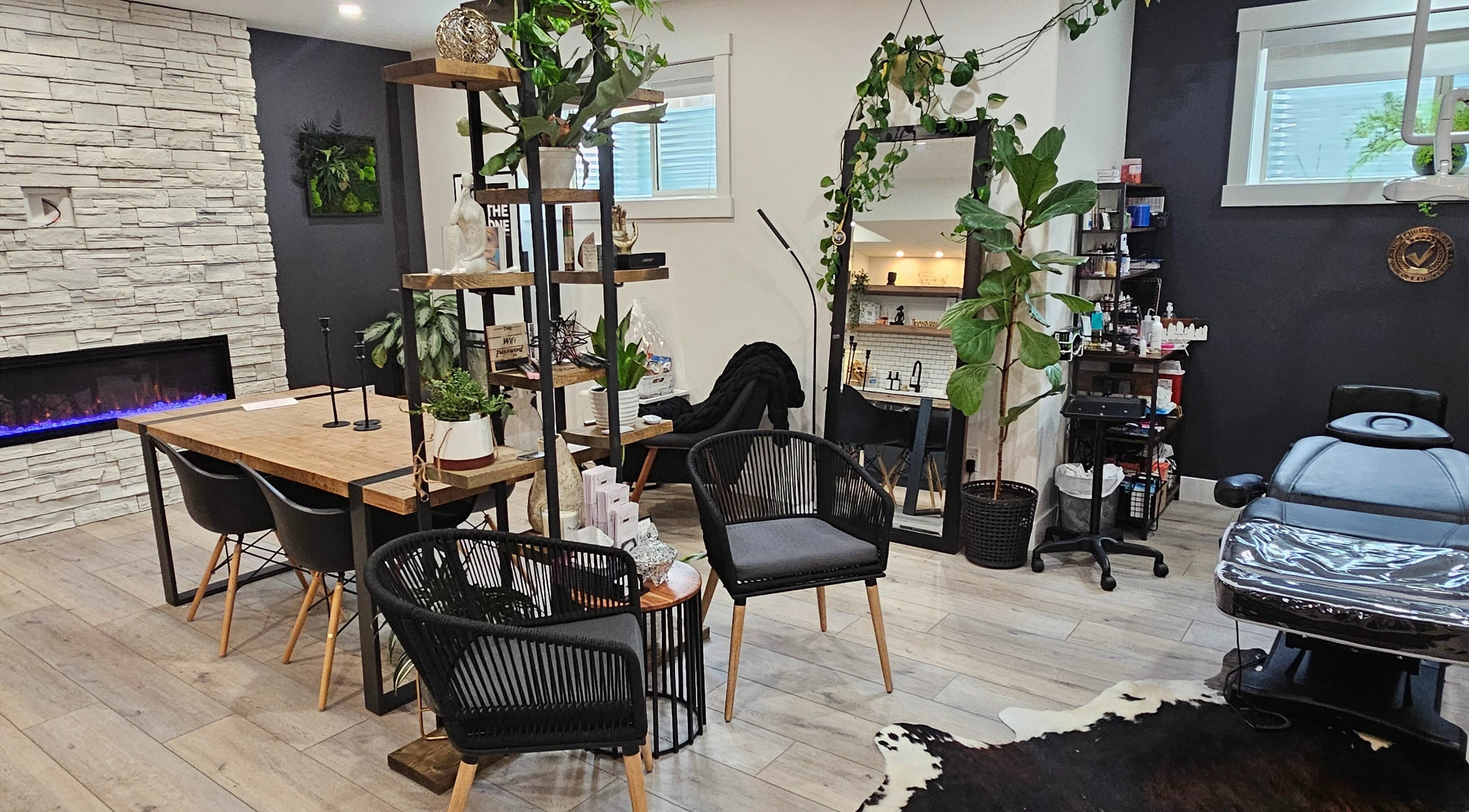Chic interior of Simply BeYoutiful PMU, St. Albert, Alberta, CA with modern furniture and greenery.