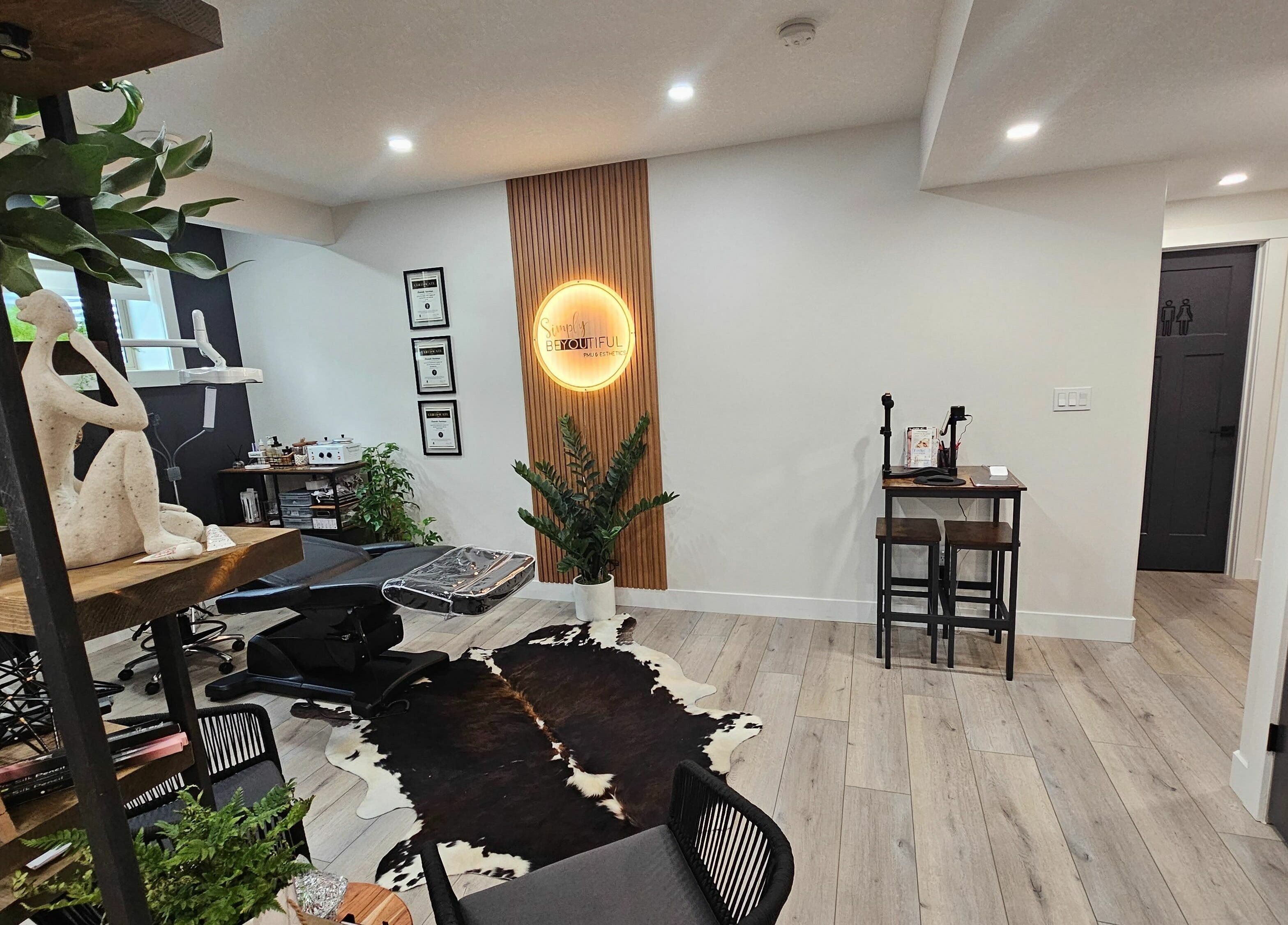 Elegant interior of Simply BeYoutiful PMU in St. Albert, Alberta, CA featuring decor and treatment area.