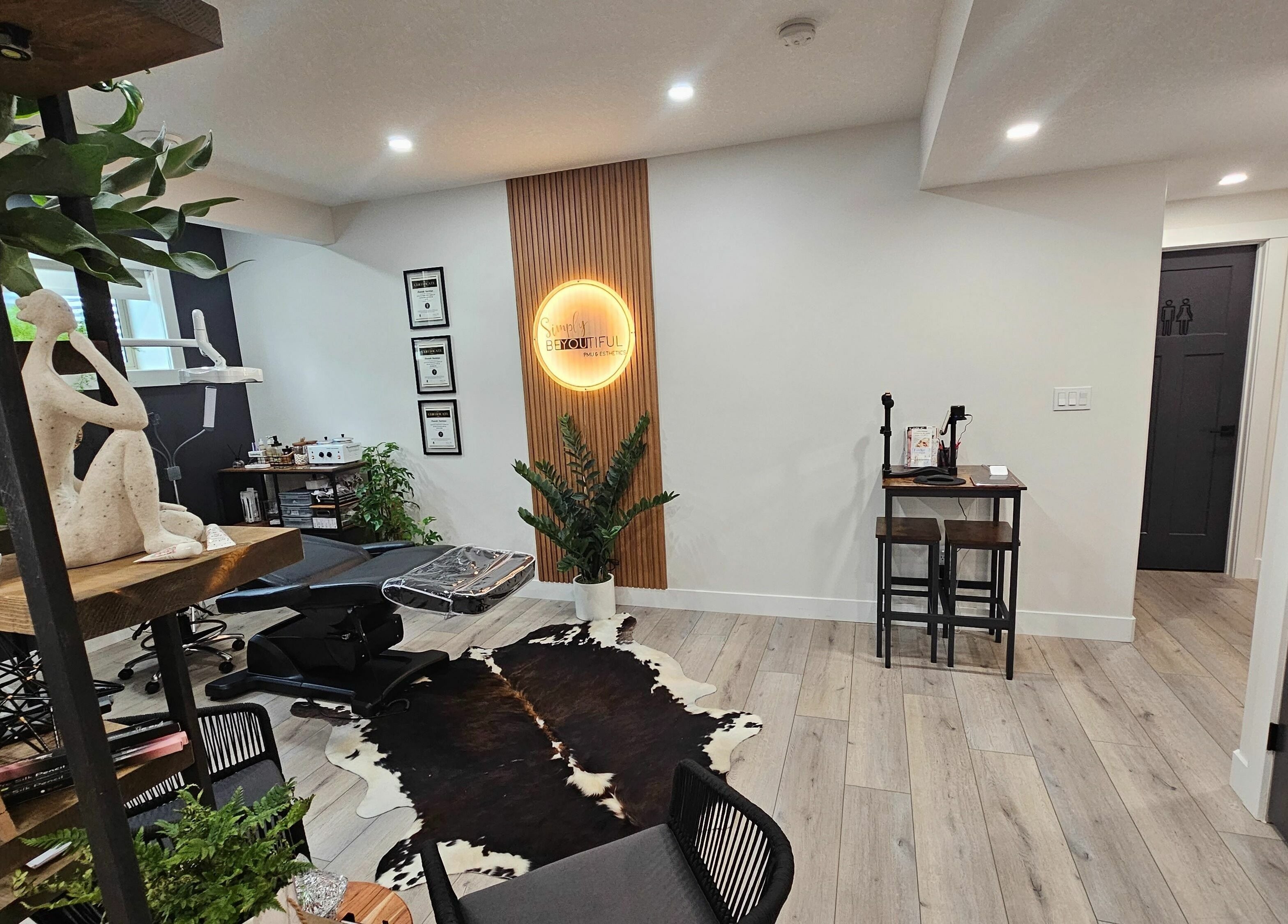 Elegant interior of Simply BeYoutiful PMU in St. Albert, Alberta, CA featuring decor and treatment area.