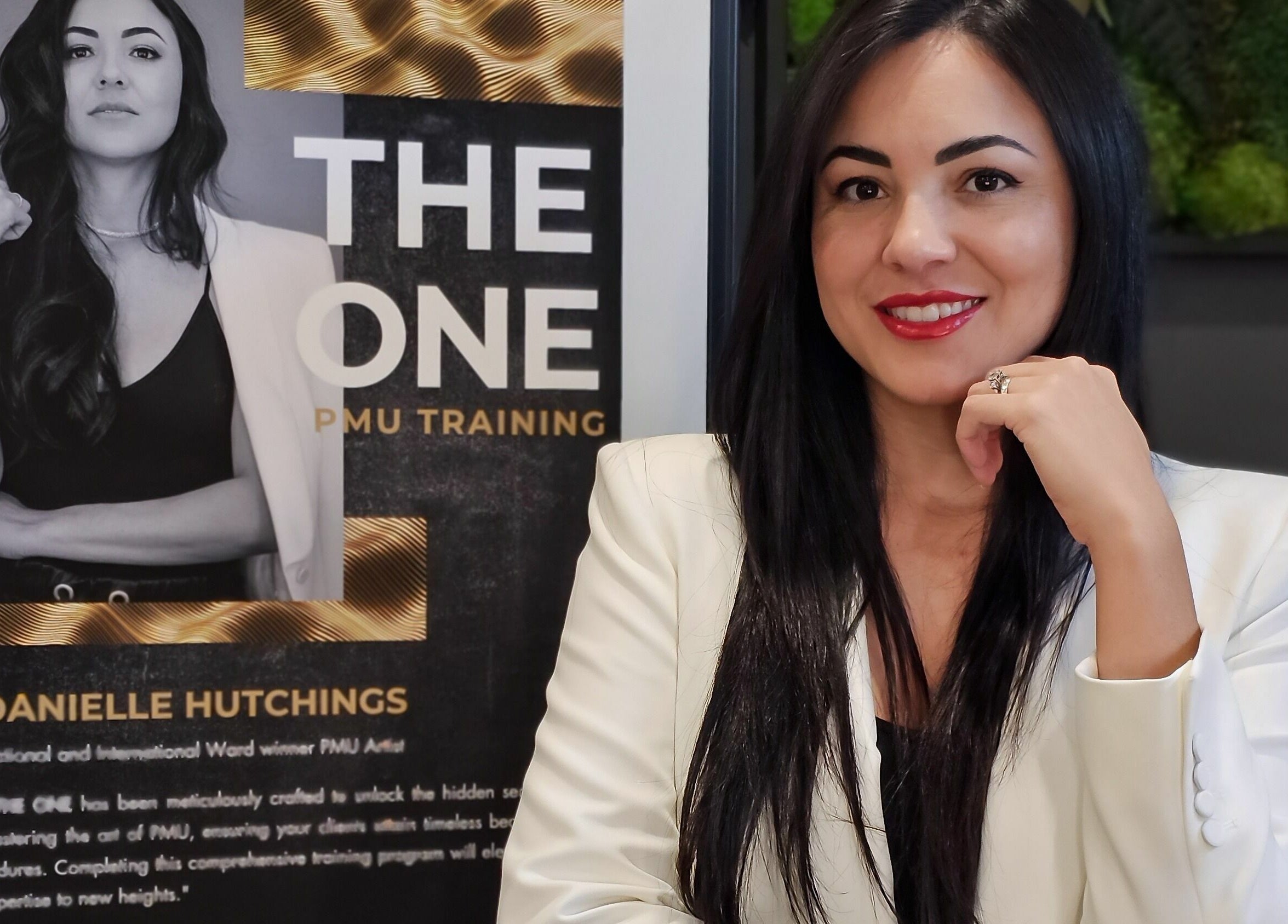 Professional PMU trainer at Simply BeYoutiful PMU in St. Albert, Alberta, CA, beside training poster.