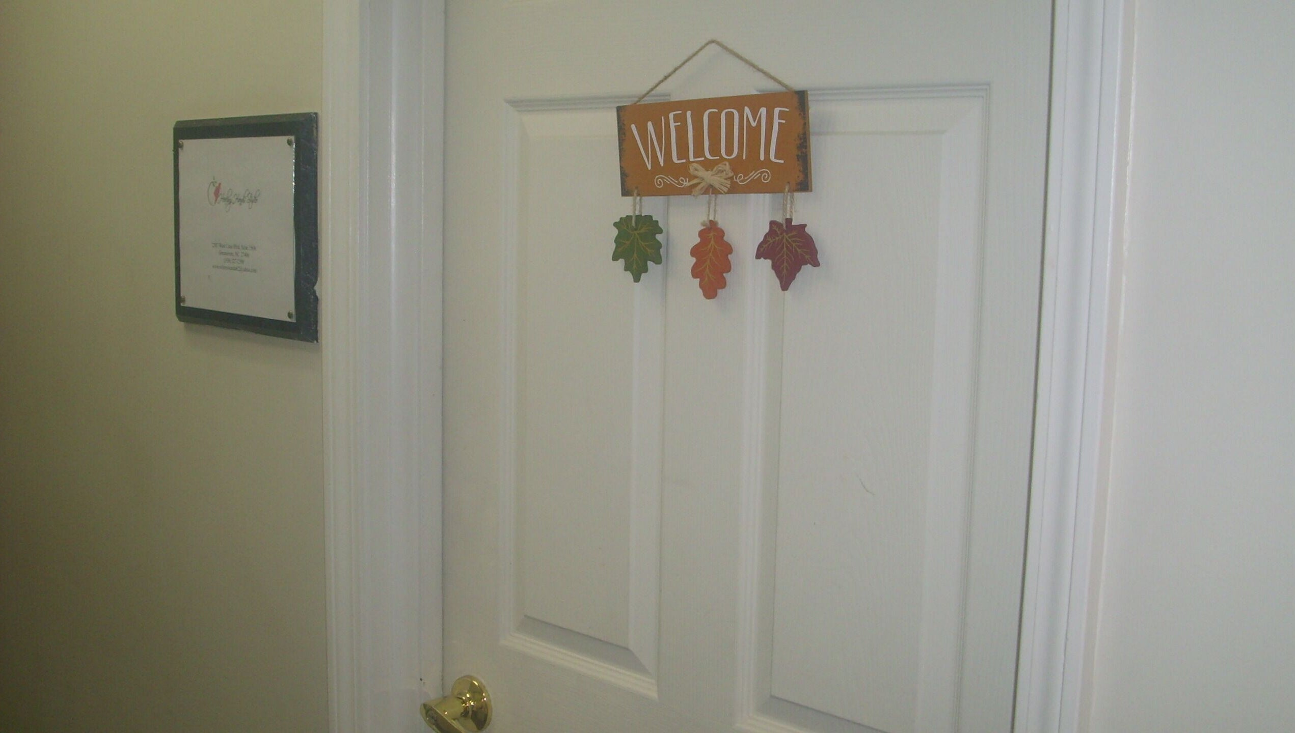 Welcome sign on a door at Healing Hands Studio NC in Greensboro, North Carolina, US.