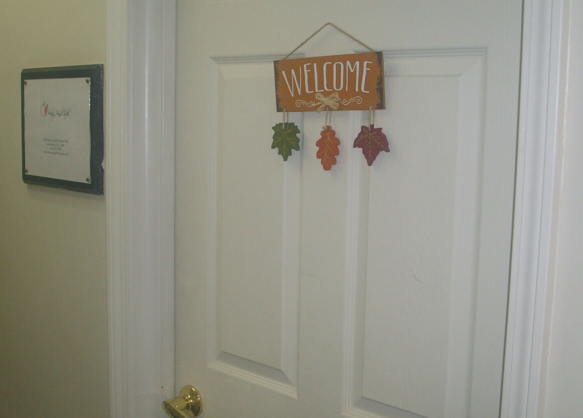 Welcome sign on a door at Healing Hands Studio NC in Greensboro, North Carolina, US.
