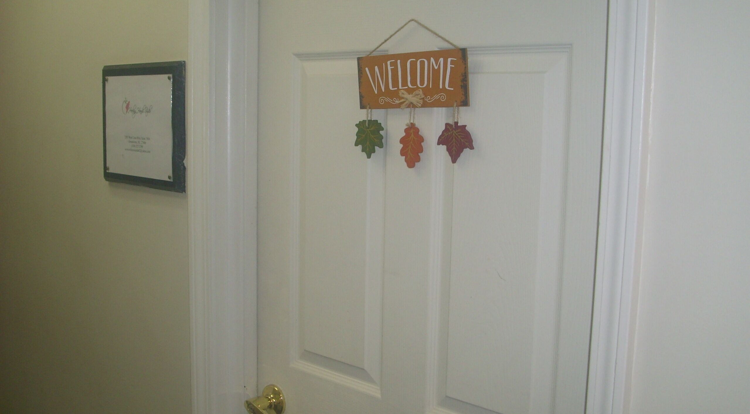 Welcome sign on a door at Healing Hands Studio NC in Greensboro, North Carolina, US.