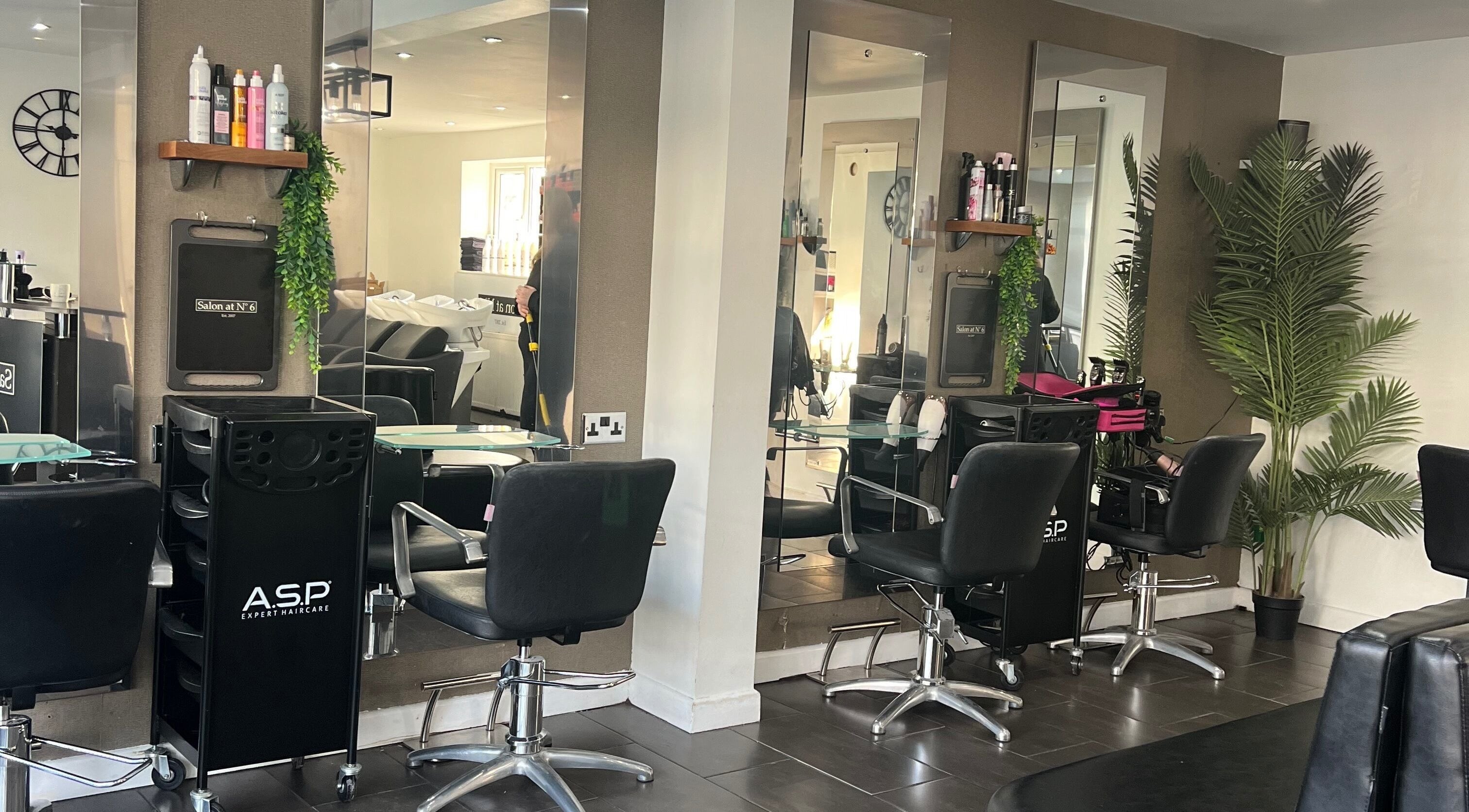 Modern salon interior at Salon at No 6, Plymouth, England, GB with styling chairs and mirrors.