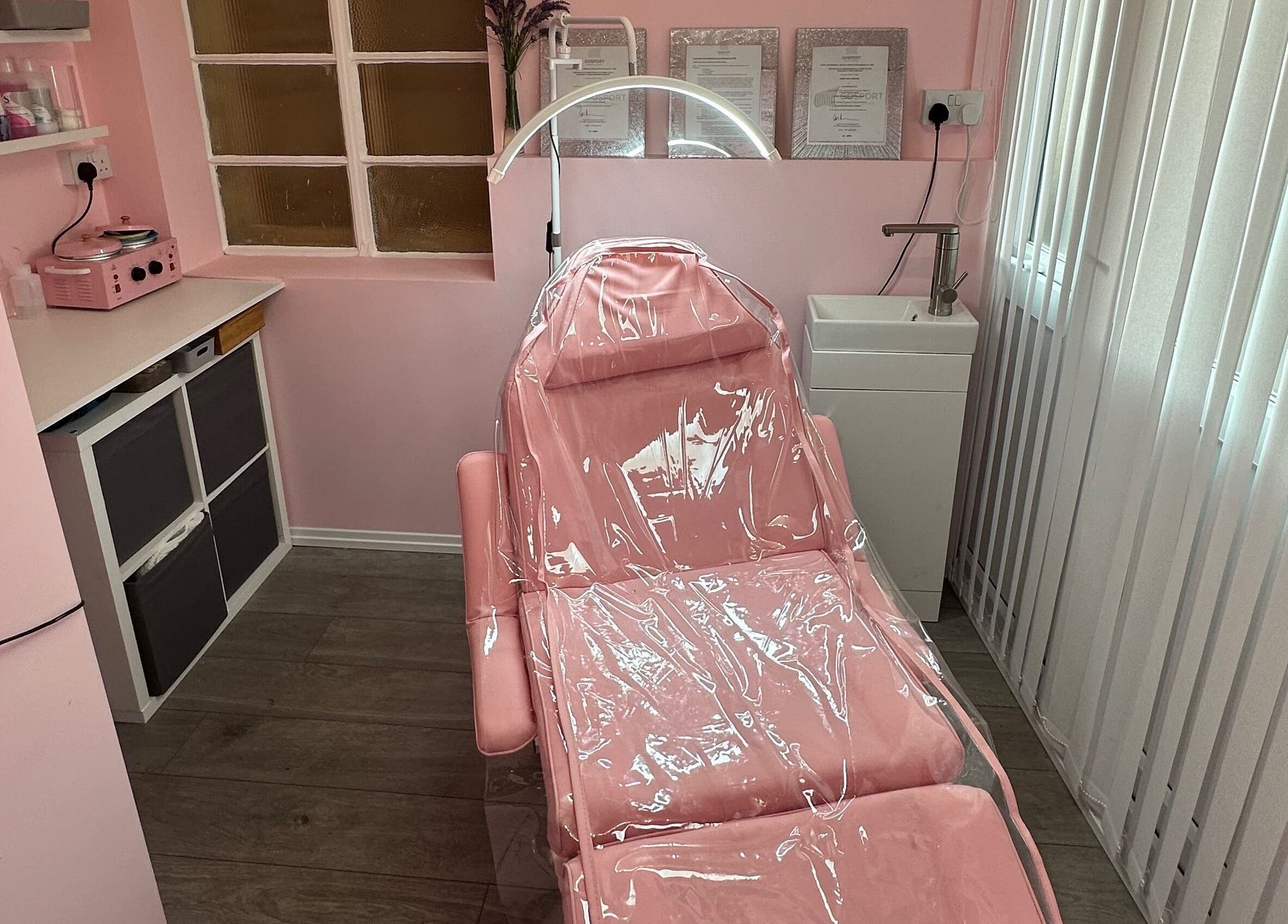 Cozy pink treatment room at Club Beauté, Lee-on-the-solent, England, GB offering tranquil wellness experience.