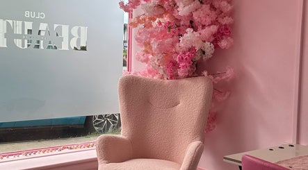 Chic seating area with pink armchair and blossoms at Club Beauté, Lee-on-the-solent, England, GB.