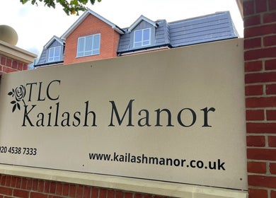 Karismha Health & Beauty Salon sign in Pinner, England, GB on a brick wall with building background.