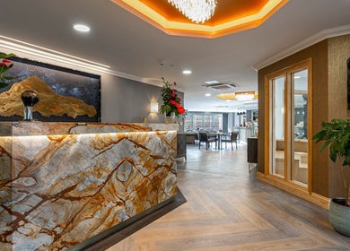 Luxurious reception at Karismha Health & Beauty Salon, Hatch End, Pinner, England. Warm lighting and chic decor.