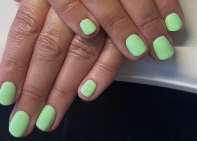 Lime green manicured nails at Mirror on the Wall, Stalham, England, GB.