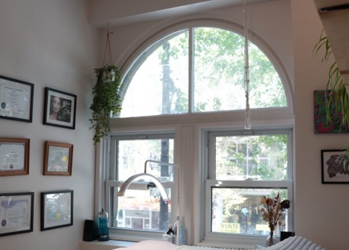 Lehita Lashes Artistry interior in Montréal, Québec, CA featuring certificates and greenery decor.