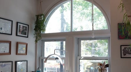 Lehita Lashes Artistry interior in Montréal, Québec, CA featuring certificates and greenery decor.