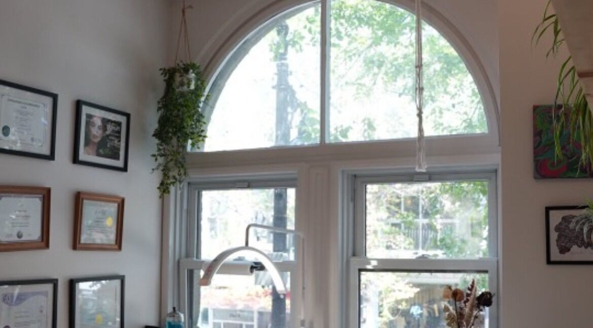 Lehita Lashes Artistry interior in Montréal, Québec, CA featuring certificates and greenery decor.