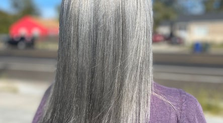 Sleek silver hair styled at America Beauty Salon, Salt Lake City, Utah, US with a vibrant background.