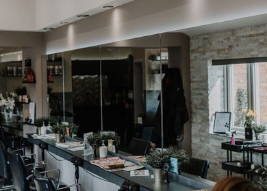 Modern interior of Halam Salon in Newark, England, GB, featuring stylish chairs and mirrors.