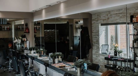 Modern interior of Halam Salon in Newark, England, GB, featuring stylish chairs and mirrors.