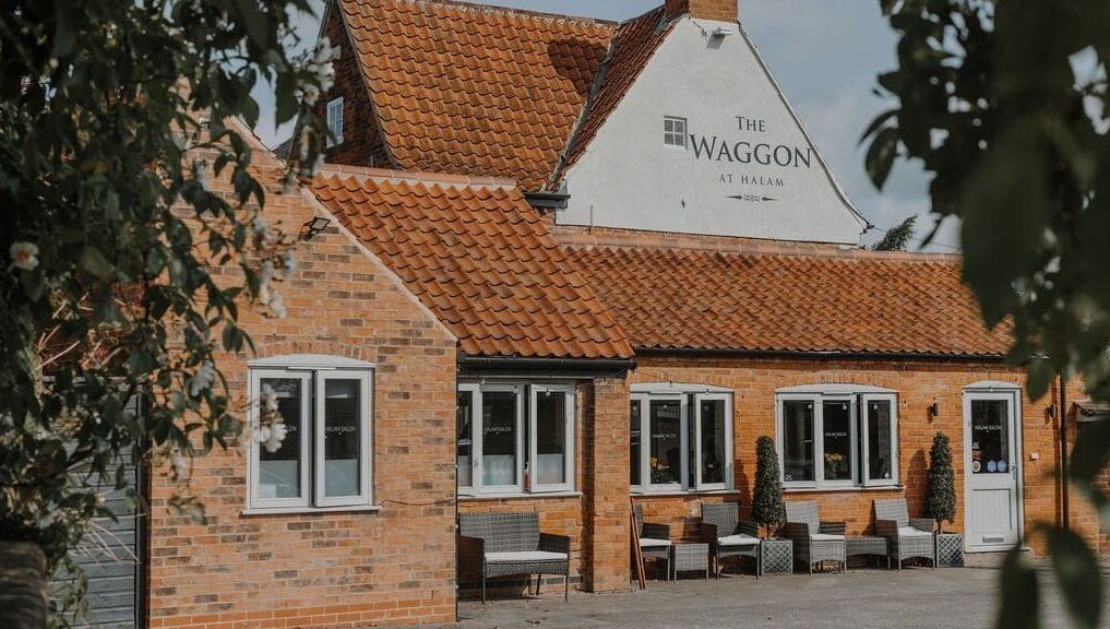 Halam Salon in Newark, England, GB showcases a charming brick exterior with inviting seating.