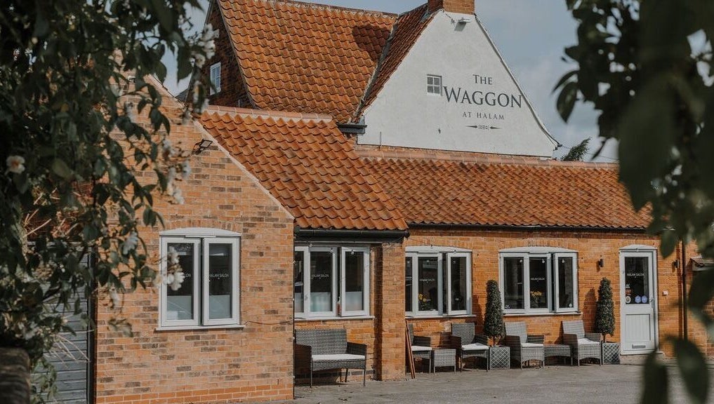 Halam Salon in Newark, England, GB showcases a charming brick exterior with inviting seating.