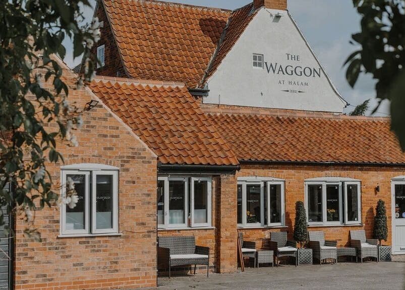 Halam Salon in Newark, England, GB showcases a charming brick exterior with inviting seating.