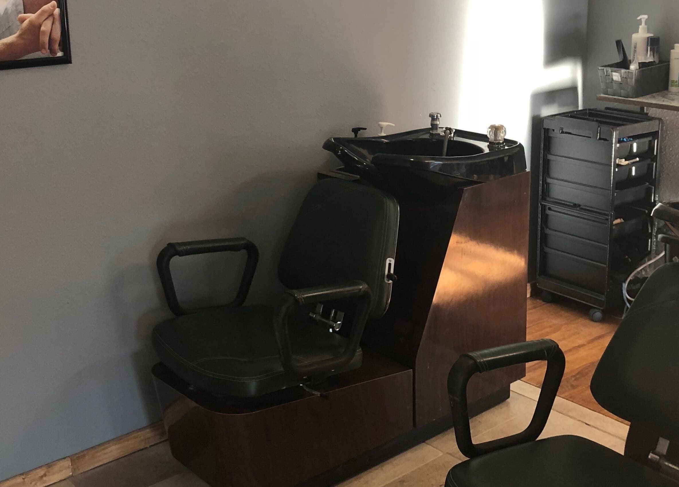 Classic barber chair and sink area at Elite Cuts Barber Salon in Chippewa Falls, Wisconsin, US.