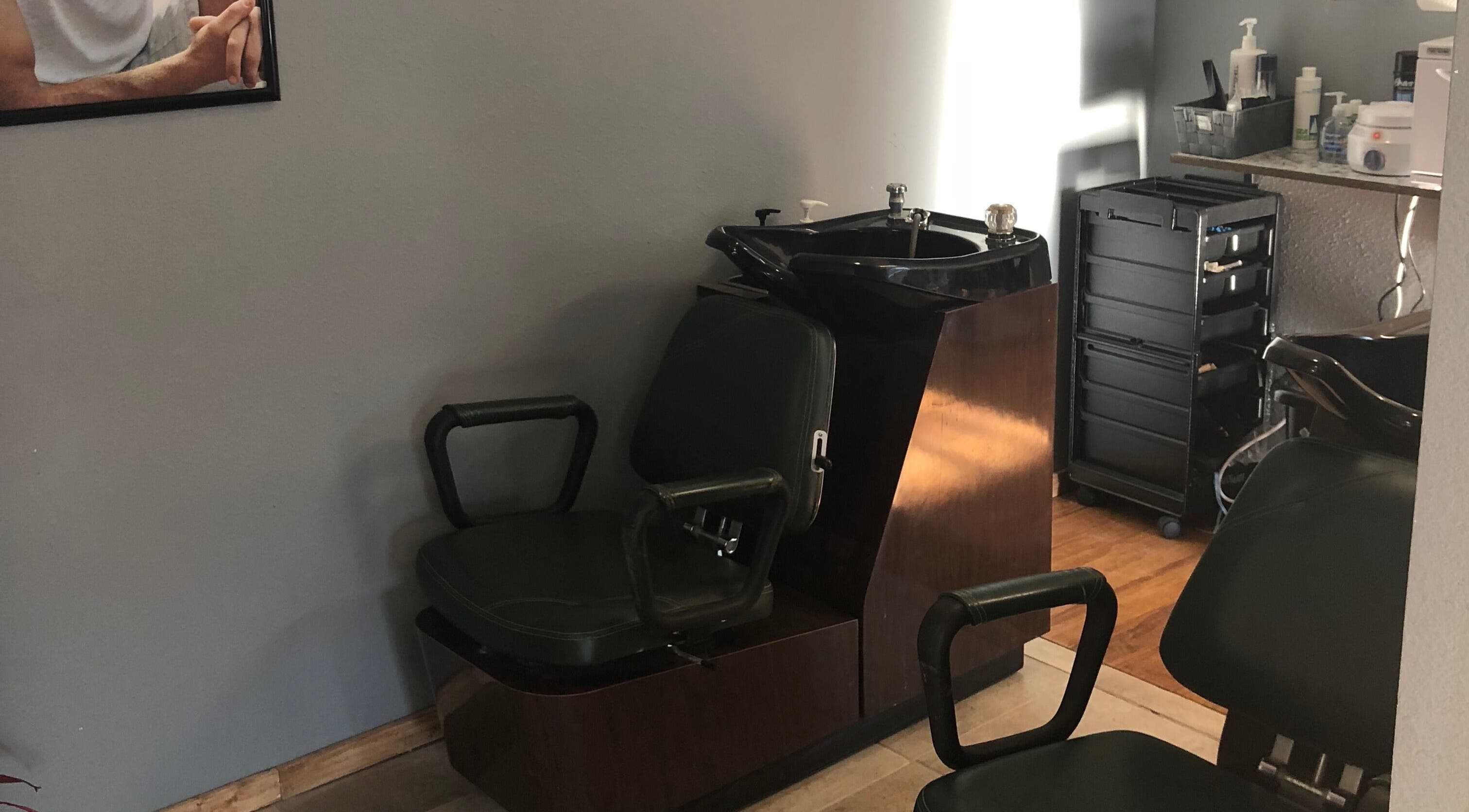Classic barber chair and sink area at Elite Cuts Barber Salon in Chippewa Falls, Wisconsin, US.