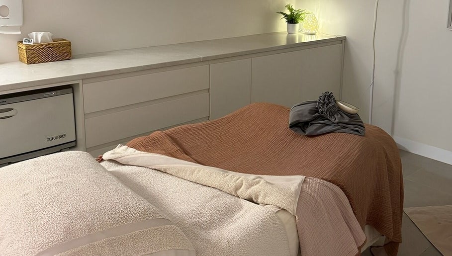 Relaxing treatment room at Indulgences, The Junction, New South Wales, AU, featuring cozy massage table.