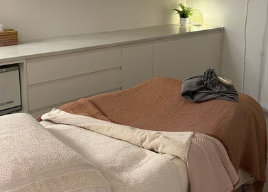 Relaxing treatment room at Indulgences, The Junction, New South Wales, AU, featuring cozy massage table.