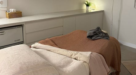 Relaxing treatment room at Indulgences, The Junction, New South Wales, AU, featuring cozy massage table.