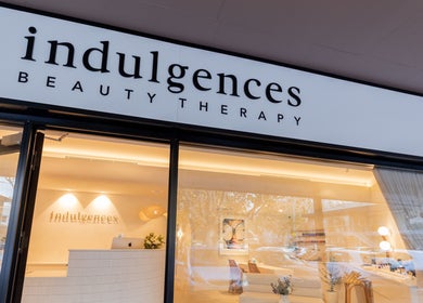 Front view of Indulgences beauty therapy at The Junction, New South Wales, AU, showcasing elegant signage.