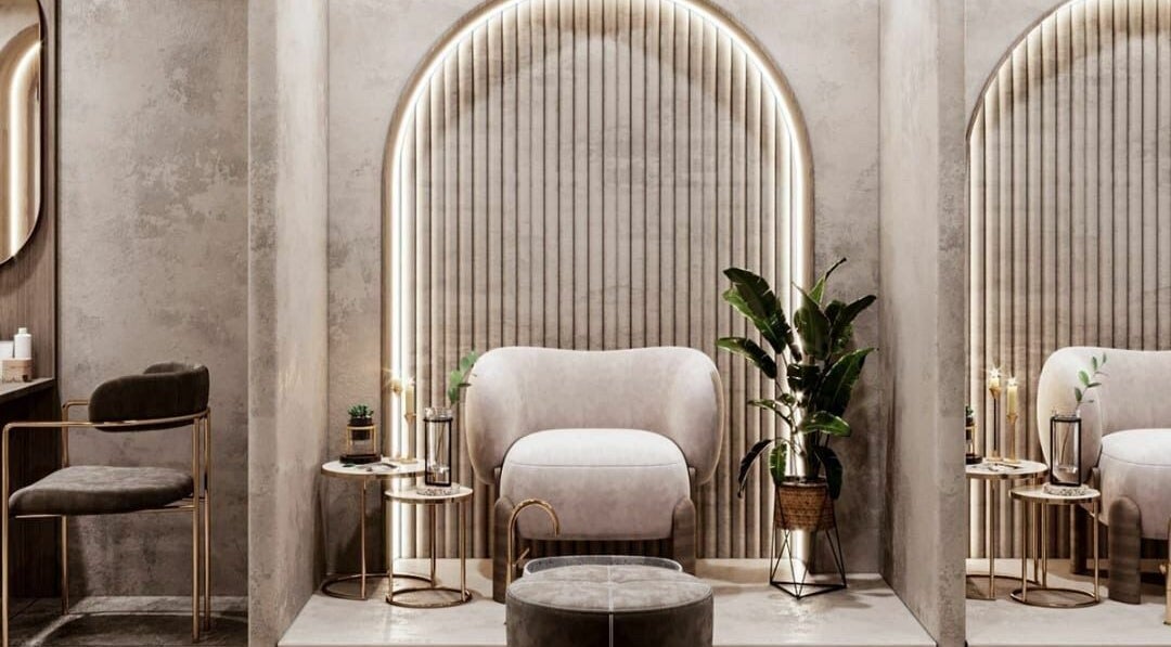Elegant seating area in Royal Nordic Beauty Salon, Dubai, AE, showcasing plush chairs and ambient lighting.