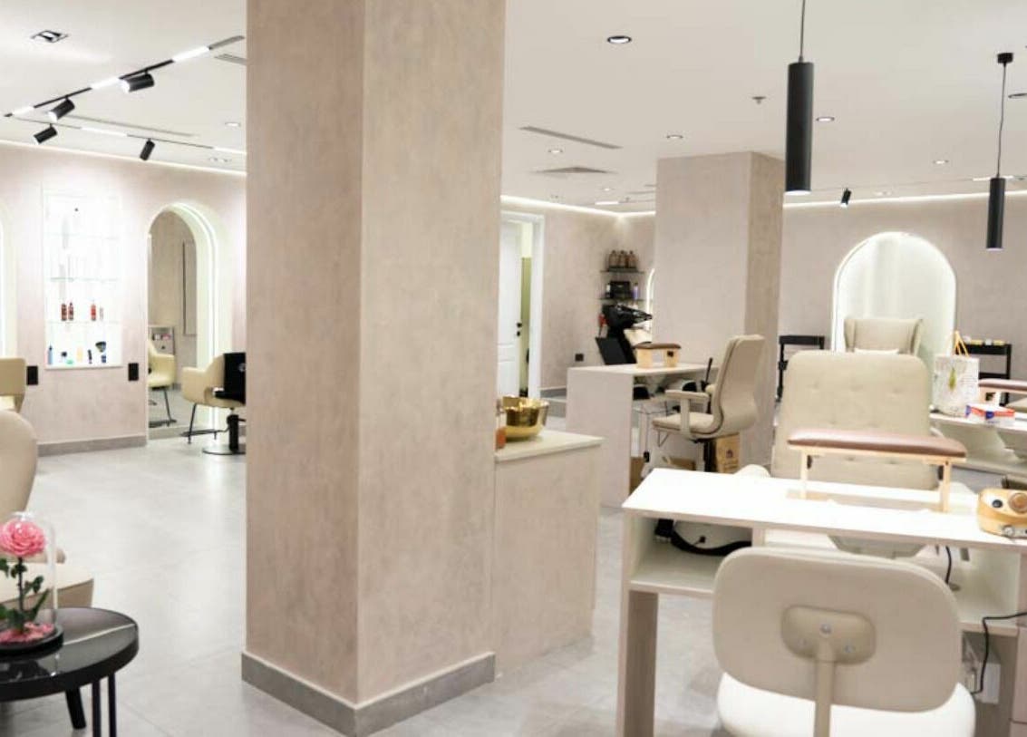 Modern, serene interior of Royal Nordic Beauty Salon, Dubai, AE, showcasing chic design and comfortable seating.