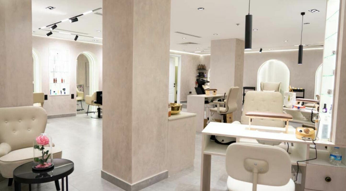 Modern, serene interior of Royal Nordic Beauty Salon, Dubai, AE, showcasing chic design and comfortable seating.