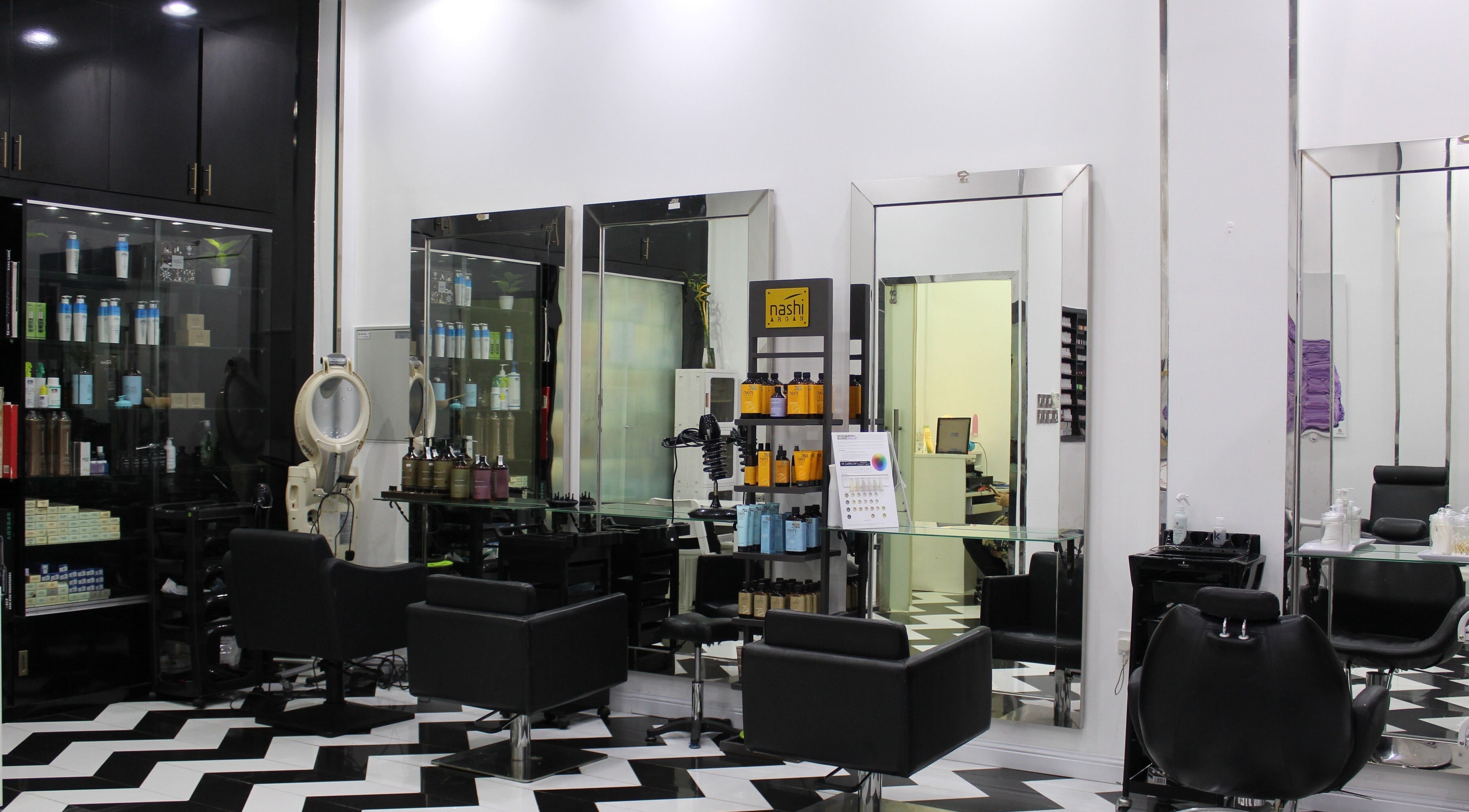 Chic interior of Beauty Corner Salon in Dubai, AE with sleek chairs and modern decor.