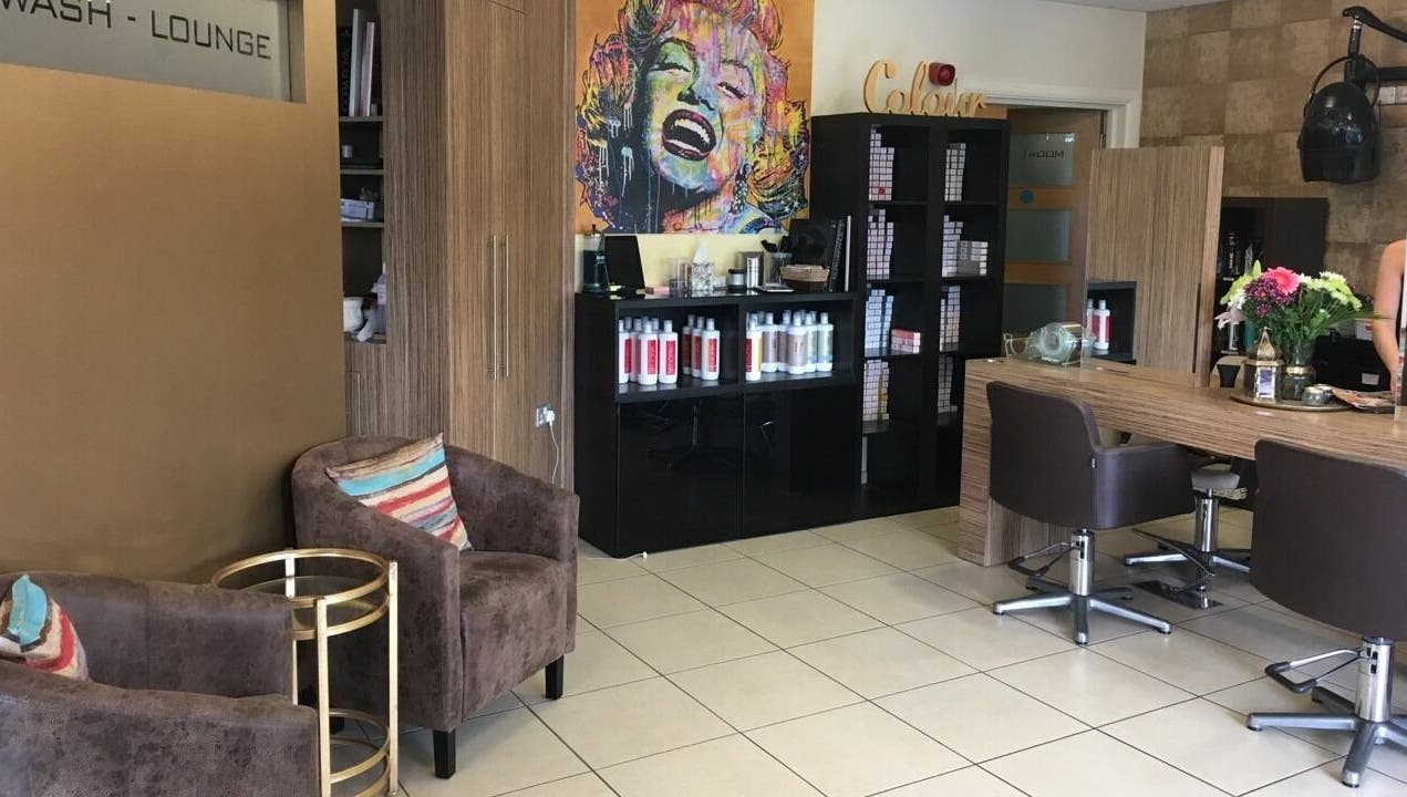 Modern interior of Principles Hair Design Ltd in Flitwick, England, GB with stylish decor and hair products.