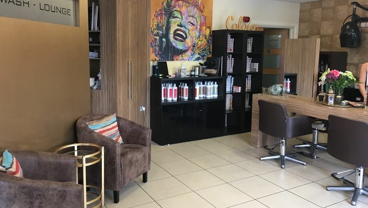 Modern interior of Principles Hair Design Ltd in Flitwick, England, GB with stylish decor and hair products.