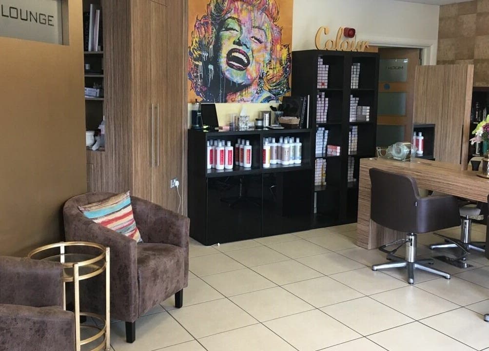Modern interior of Principles Hair Design Ltd in Flitwick, England, GB with stylish decor and hair products.