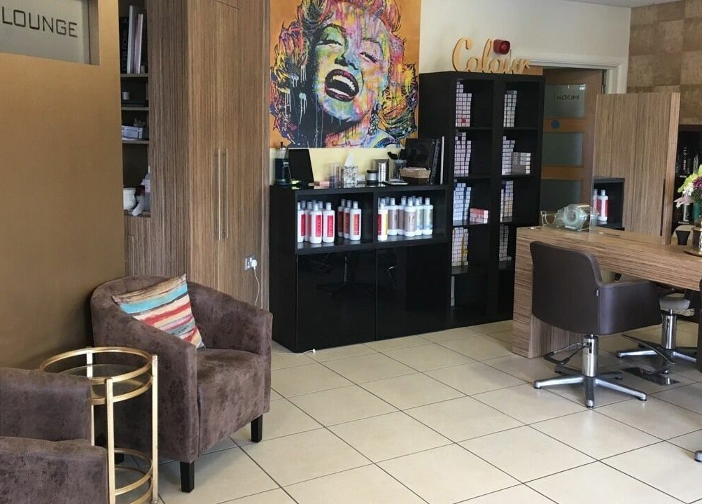 Modern interior of Principles Hair Design Ltd in Flitwick, England, GB with stylish decor and hair products.