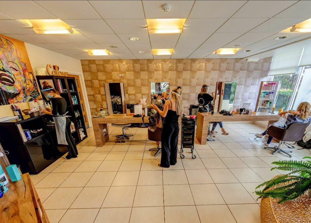 Interior of Principles Hair Design Ltd in Flitwick, England, GB showcasing styling stations and modern decor.
