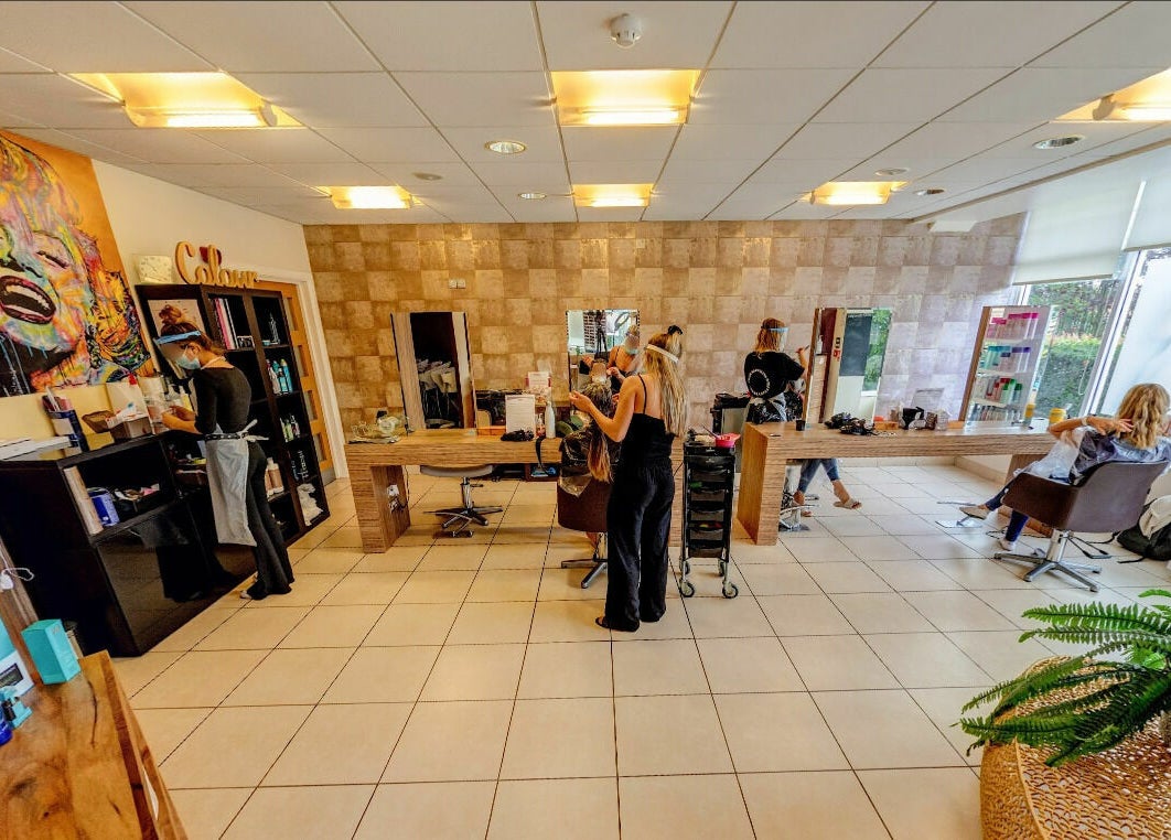 Interior of Principles Hair Design Ltd in Flitwick, England, GB showcasing styling stations and modern decor.