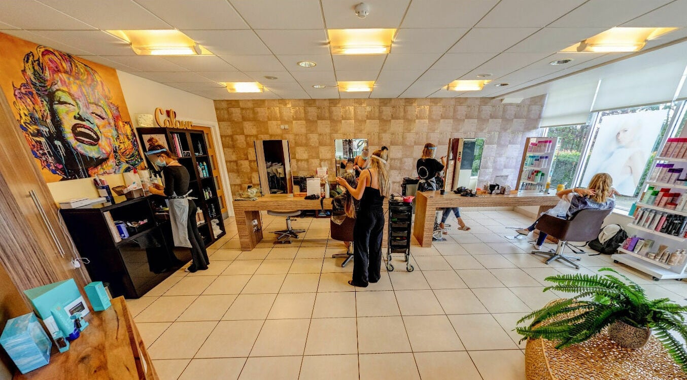 Interior of Principles Hair Design Ltd in Flitwick, England, GB showcasing styling stations and modern decor.