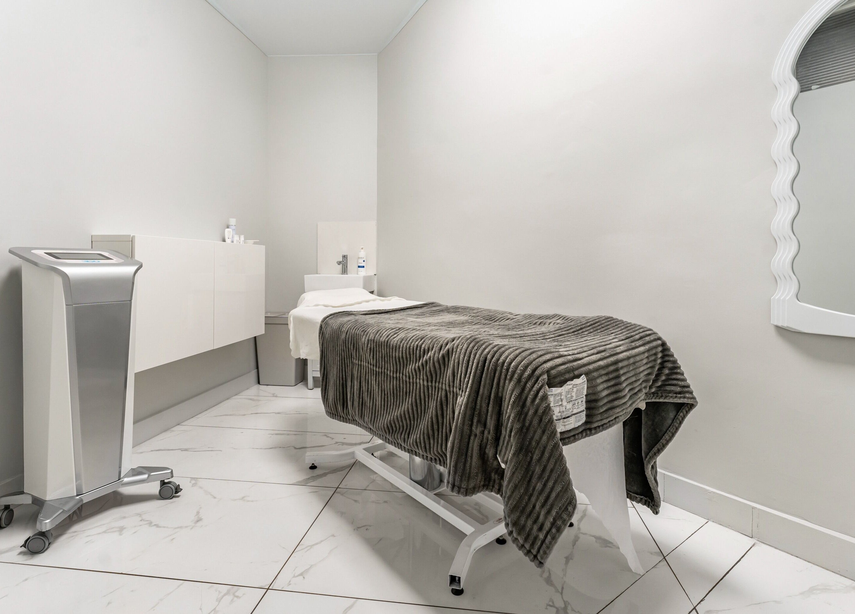 Luxurious treatment room at Cosmo, Montréal, Québec, CA with plush bed and modern decor for ultimate relaxation.