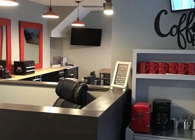 Cozy interior of Gents Barber Shop with coffee bar in Hampton, New Hampshire, US.