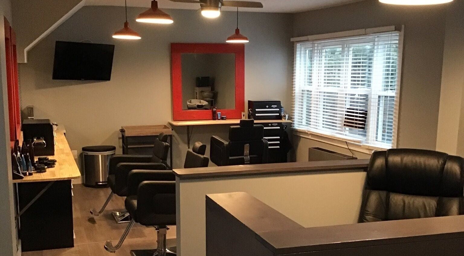 Stylish interior of Gents Barber Shop in Hampton, New Hampshire, US, featuring leather chairs and modern decor.