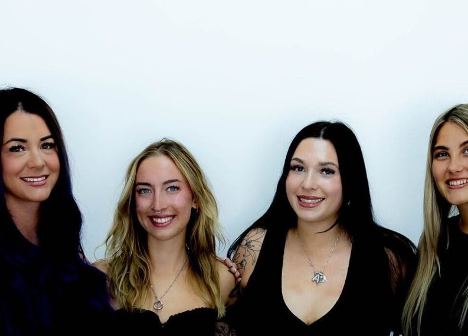 Team of stylists at D's Lashes & Esthetics in Spruce Grove, Alberta, CA, smiling against a white background.