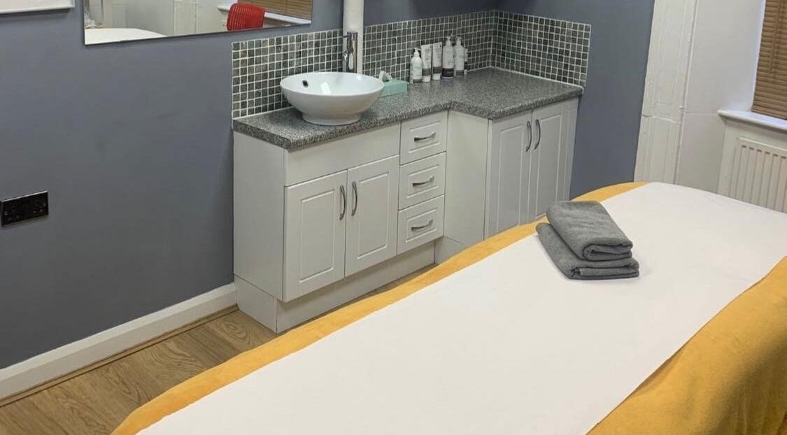 Calm massage room at VIP Beauty, Halifax, England featuring a cozy bed and spa essentials.